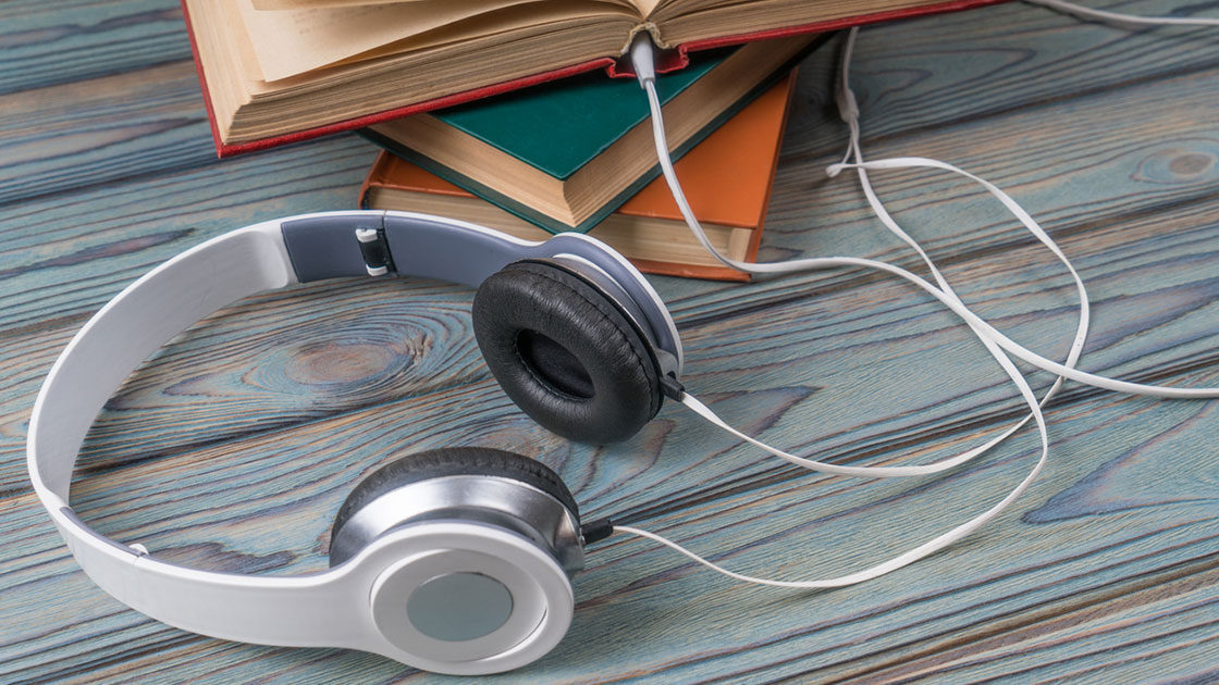 Headphones plugged into books