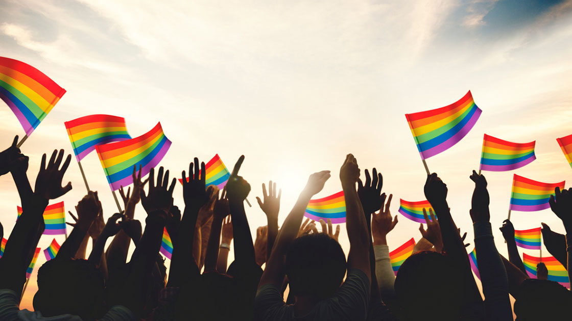 LGBTQ+ pride flags waving in celebration