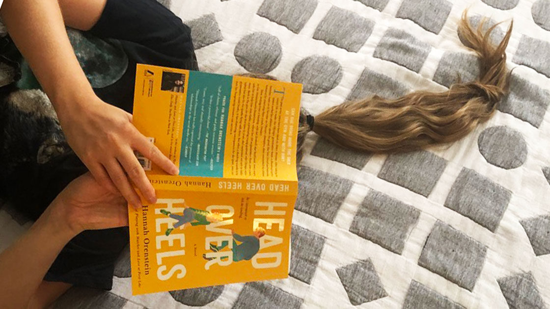 Reading Head Over Heels on a bed