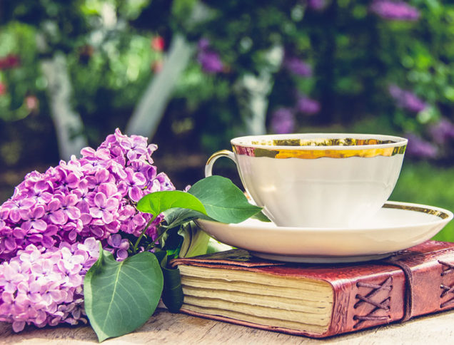 Tea cup and book in a garden