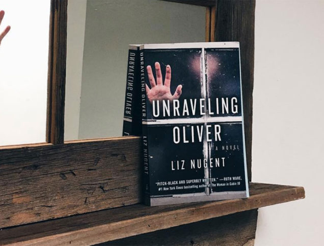 Unraveling Oliver book with hand against window